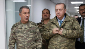 epa06474038 A handout photo made available by the Turkish Presidential Press Office shows Turkish President Recep Tayyip Erdogan (R) and Turkish Chief of Staff General Hulusi Akar (L) at the a military command center which is commanded of Olive Branch in Hatay, Turkey, 25 January 2018. Reports state that the Turkish army is on an operation 'named 'Operation Olive Branch' in Syria's northern regions against the Kurdish Popular Protection Units (YPG) forces which control the city of Afrin. Turkey classifies the YPG as a terrorist organization. EPA/TURKISH PRESIDENTAL PRESS OFFICE HANDOUT HANDOUT EDITORIAL USE ONLY/NO SALES